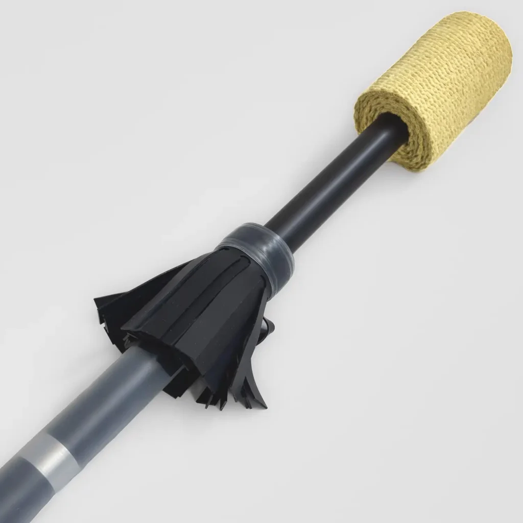 closeup shot of end piece of a fire contact staff highlighting the black flowers