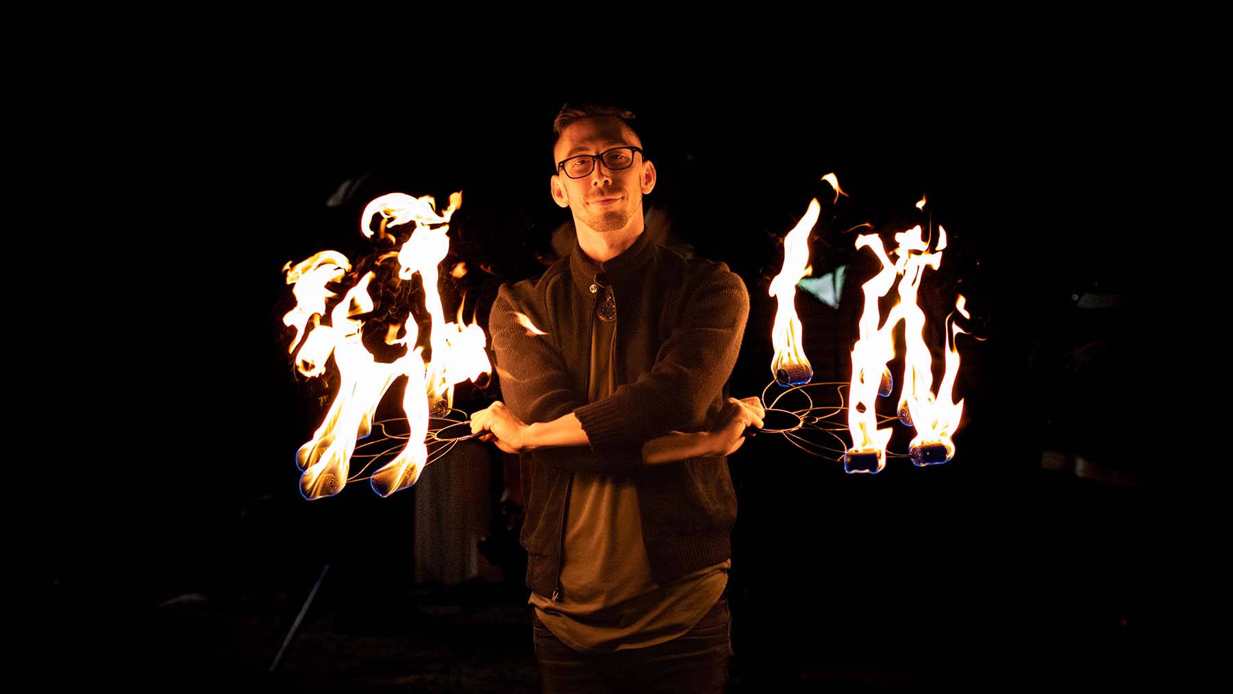 fire performer with fire lotus fans