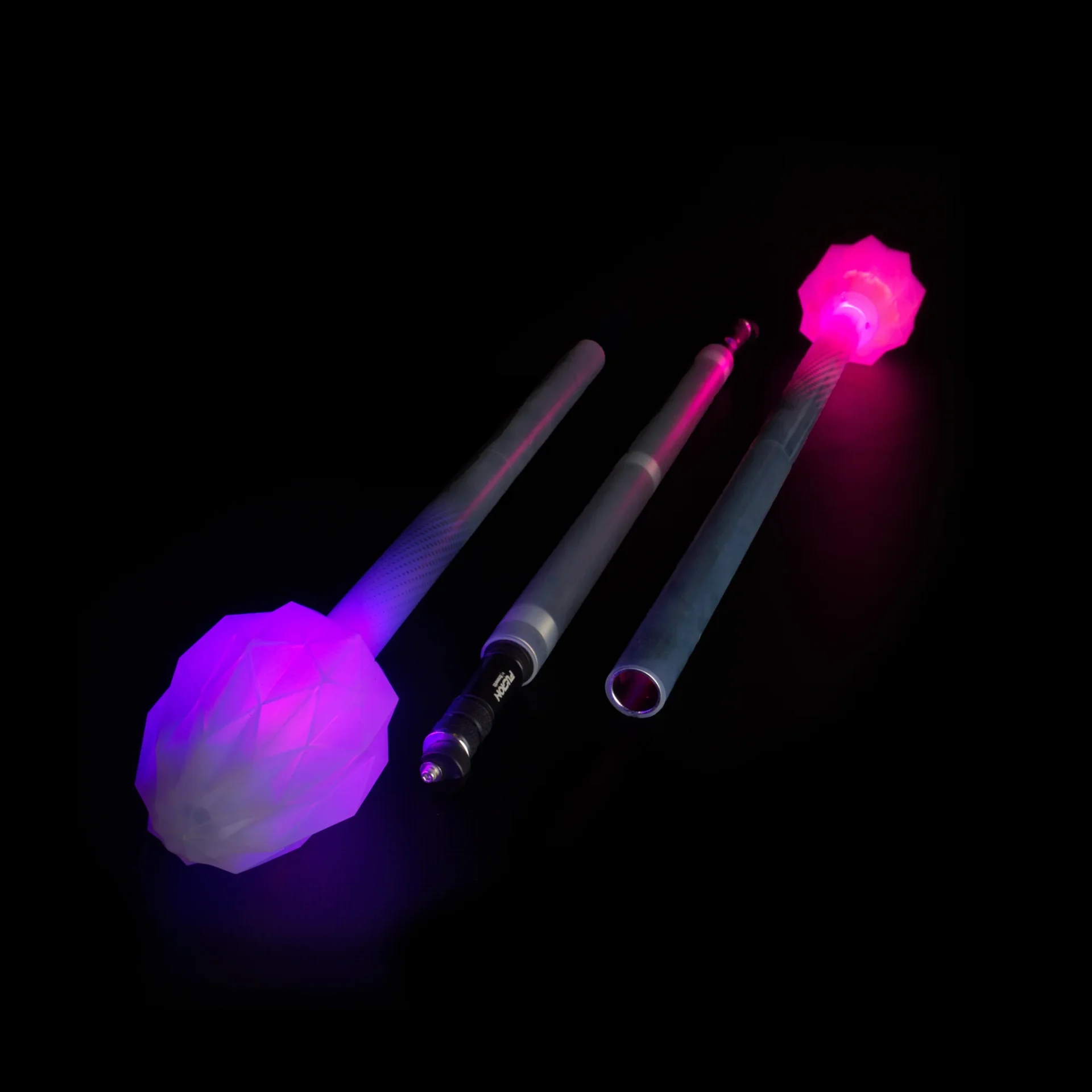 full shot of lit up led fusion prism 3 piece collapsible staff in a dark room