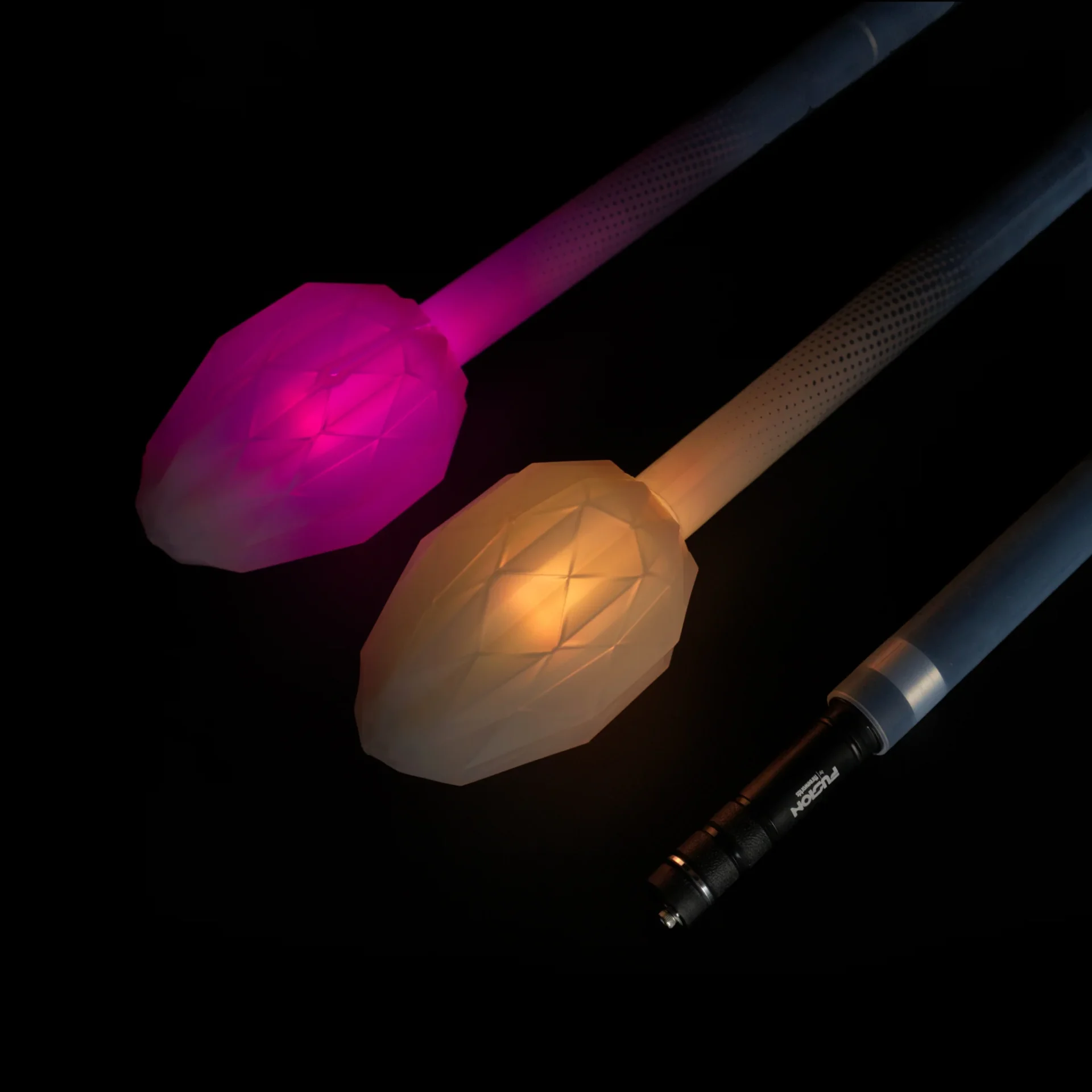 Closeup of lit up led fusion prism 3 piece collapsible staff in a dark room
