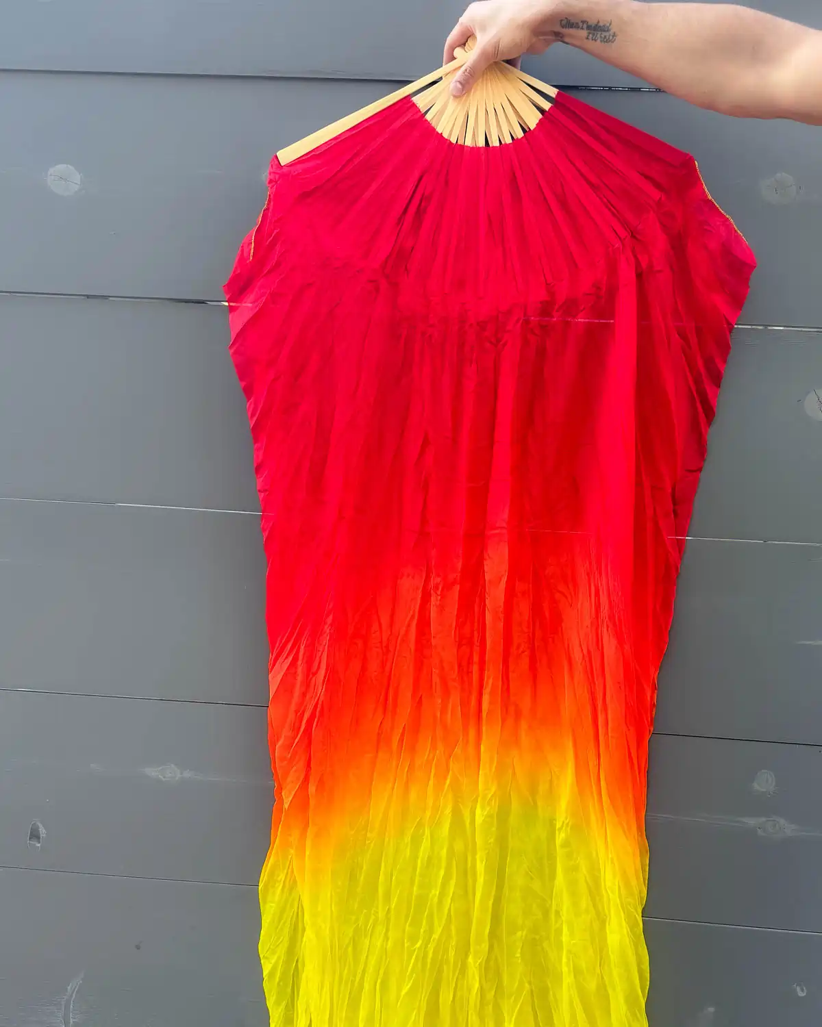 layflat image showing red orange and yellow colors on a pair of silk fans