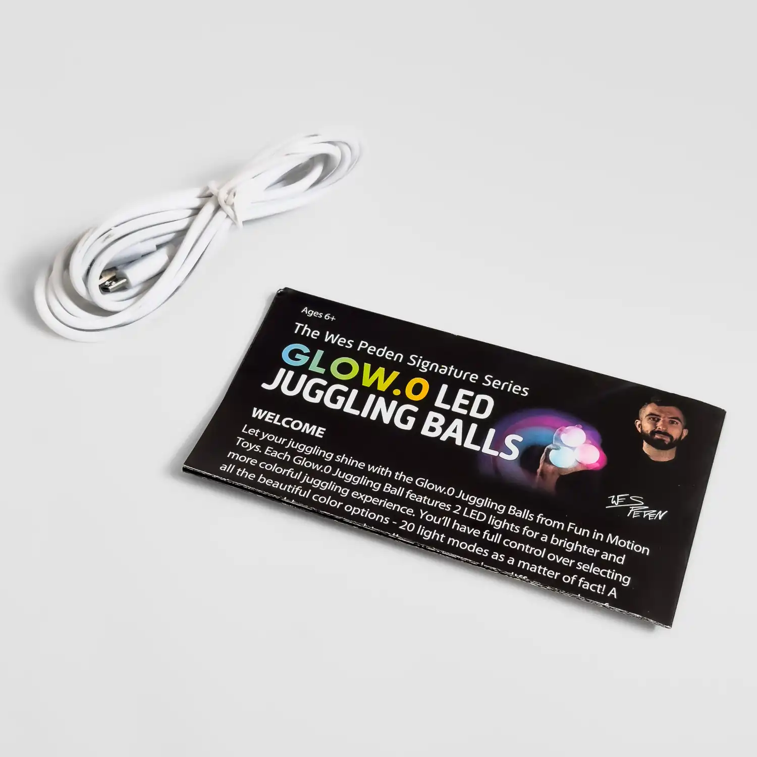 full shot of juggle ball charging cable and instruction booklet