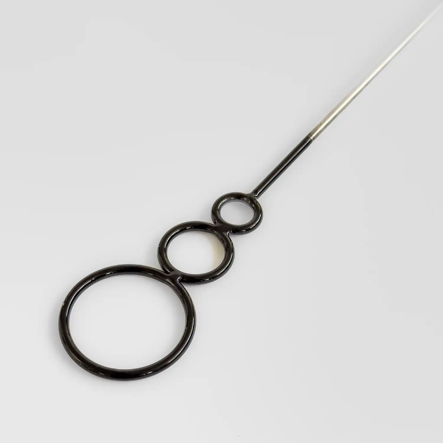 closeup shot of the welded rings of a kevlar fire wand with black paint coating