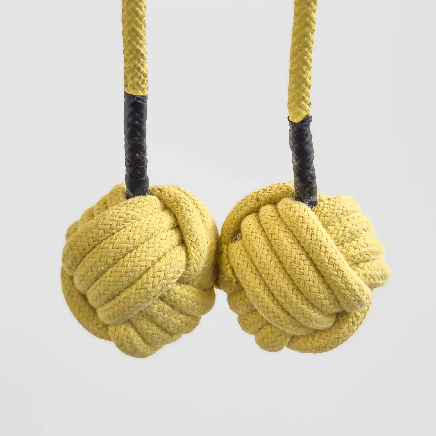 closeup shot of a pair of kevlar monkey fist heads on a pair of fire poi