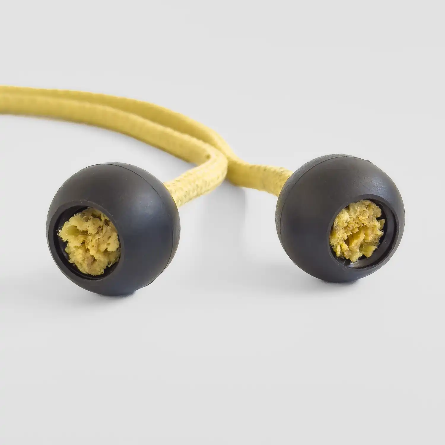 closeup shot of large black poi knobs on a set of fire poi