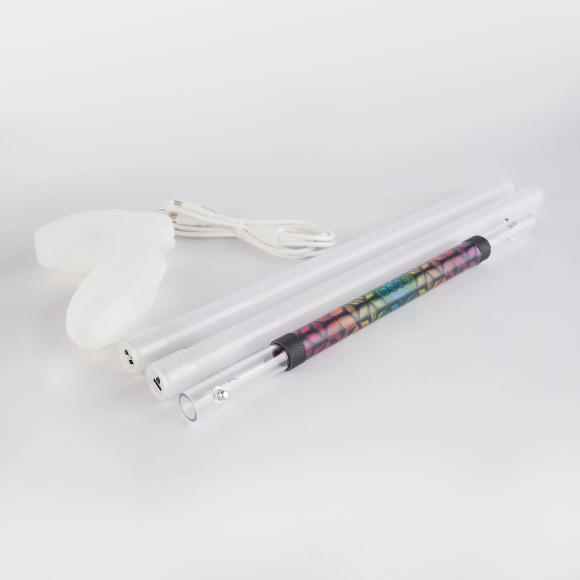 unassembled lumi spin staff showing all pieces and charging cable