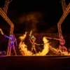 Action shot of performing using fire sword with lycopodium powder