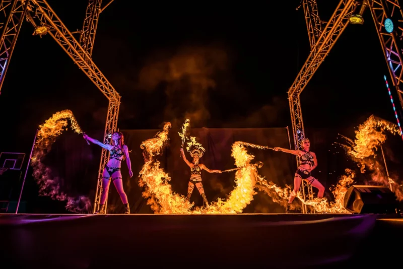 Action shot of performing using fire sword with lycopodium powder