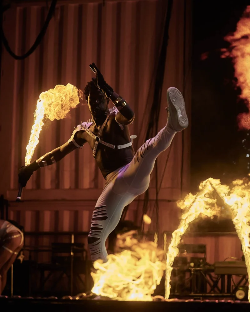 Action shot of performing using fire sword with lycopodium powder
