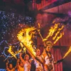Action shot of performing using fire sword with lycopodium powder