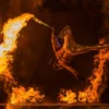 Action shot of performing using fire sword with lycopodium powder