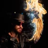 Closeup face shot of flowchucker with fire scythe using flow sparks