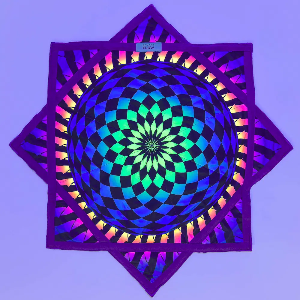 full shot of flow star under uv light with checkerboard mandala design