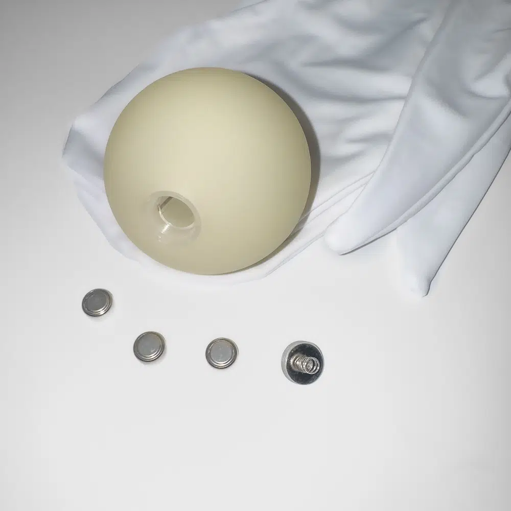 closeup of the led ball and the batteries used for this fabric sock poi