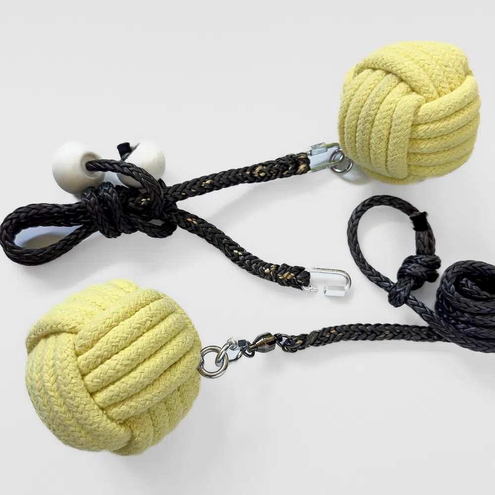 monkey fist fire rope dart and poi laying side by side