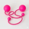 Full shot of a pair of pink contact poi with large silicone knobs